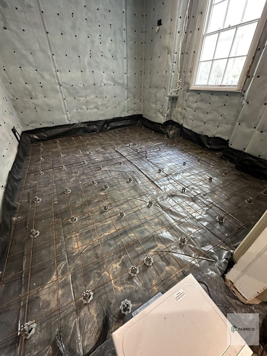 Basement waterproofing in progress — full wall coverage