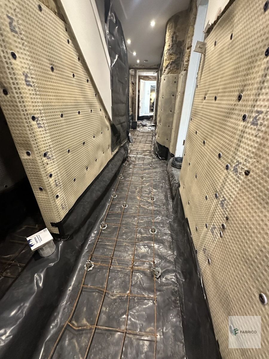 Basement corridor — membrane and floor waterproofing with rebar