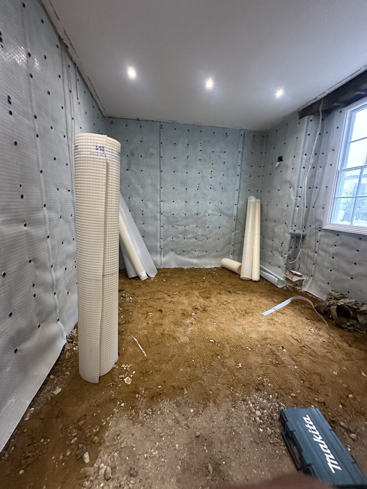 Basement waterproofing — cavity drain membrane installation