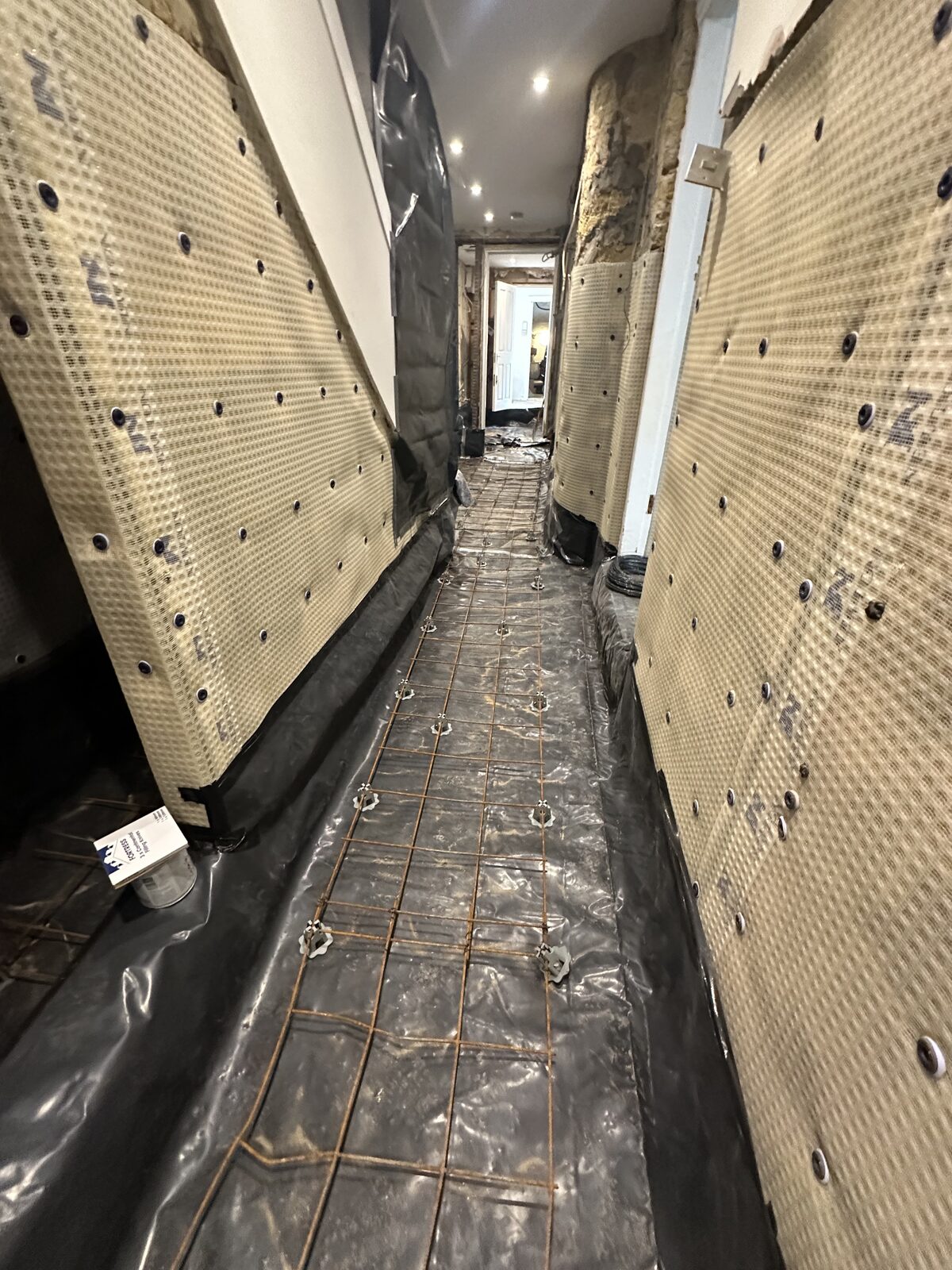 Basement corridor — membrane and floor waterproofing with rebar