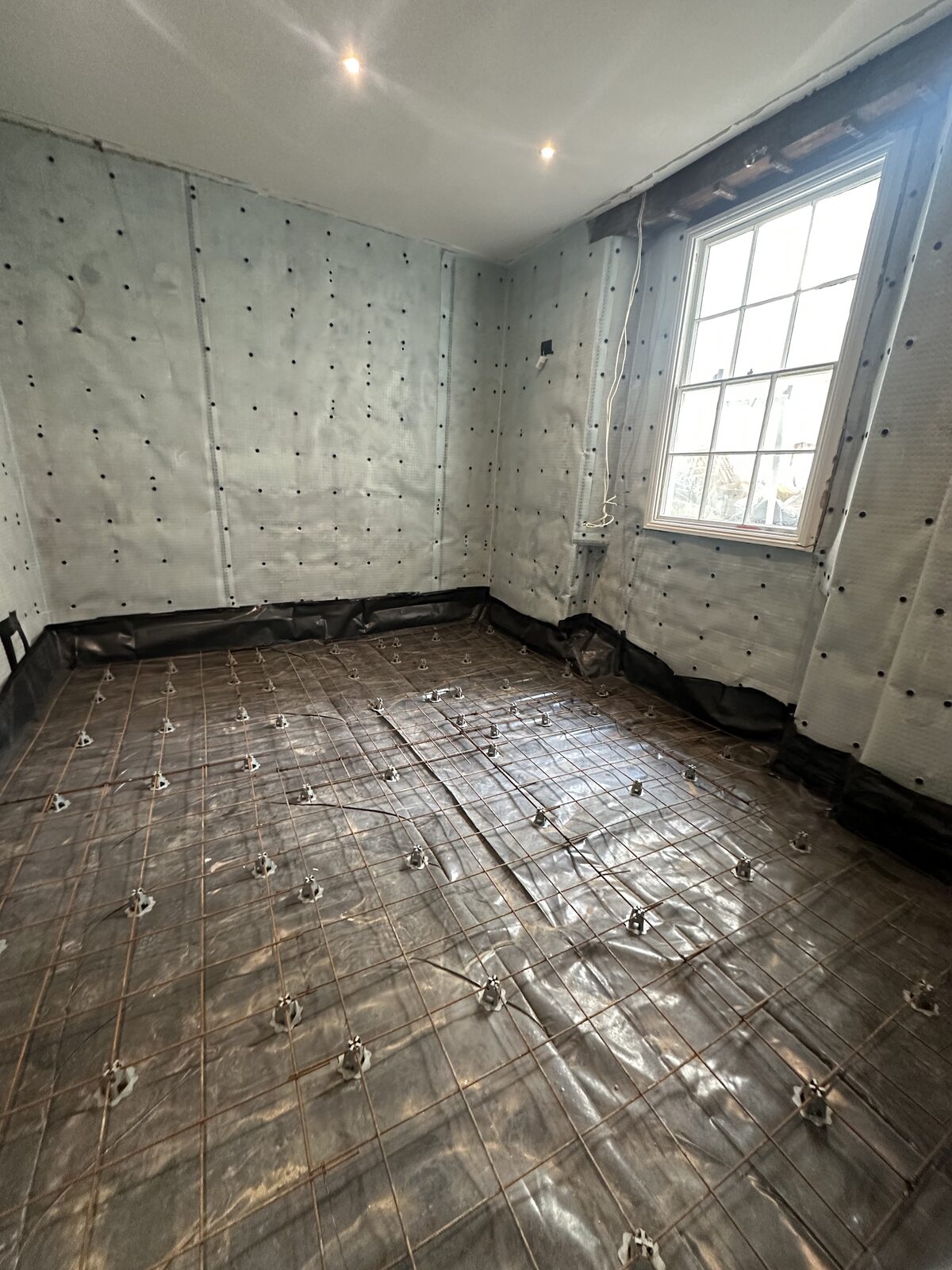 Basement floor — rebar mesh ready for concrete slab