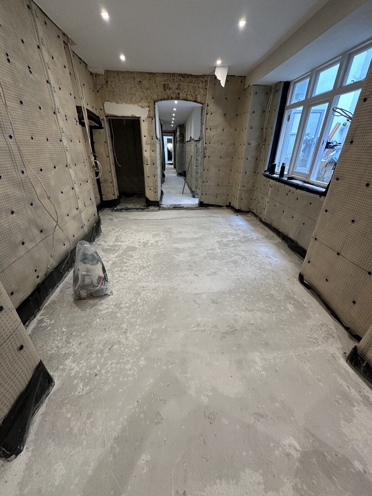 Basement hallway — membrane walls with new concrete floor