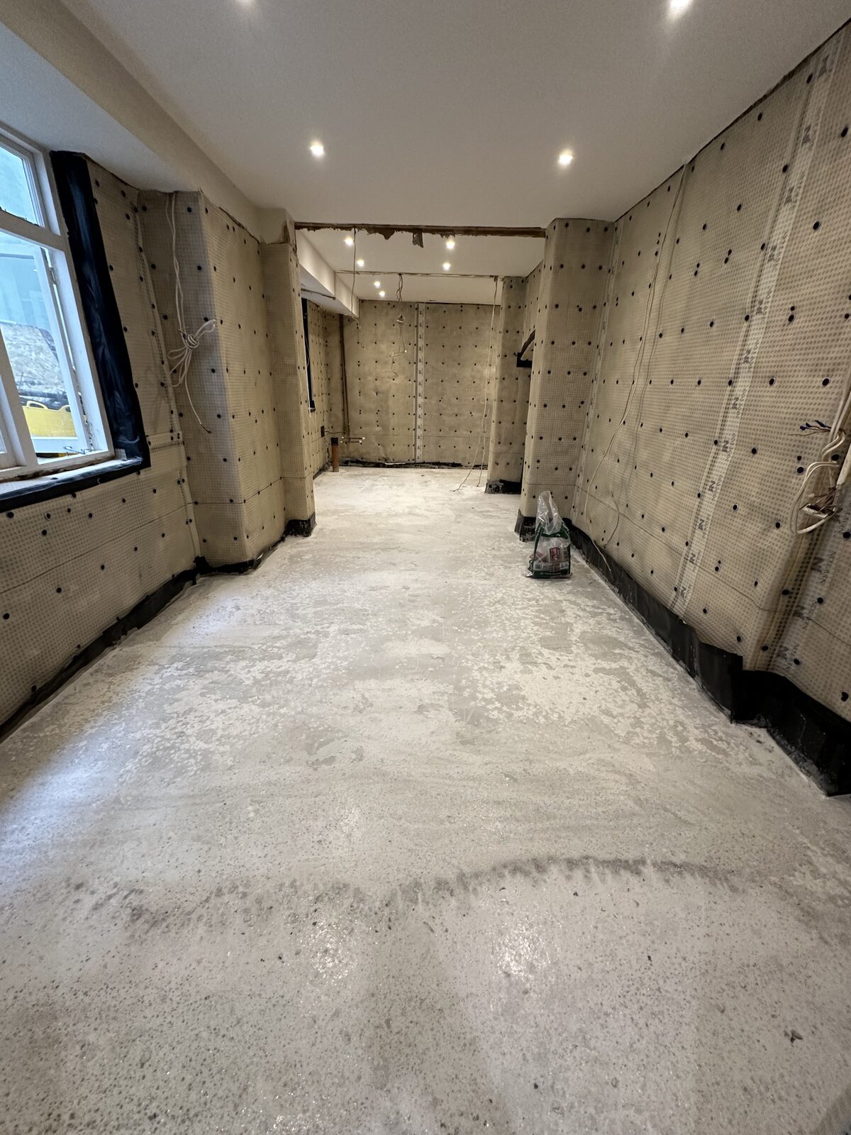 Completed basement waterproofing — ready for drylining